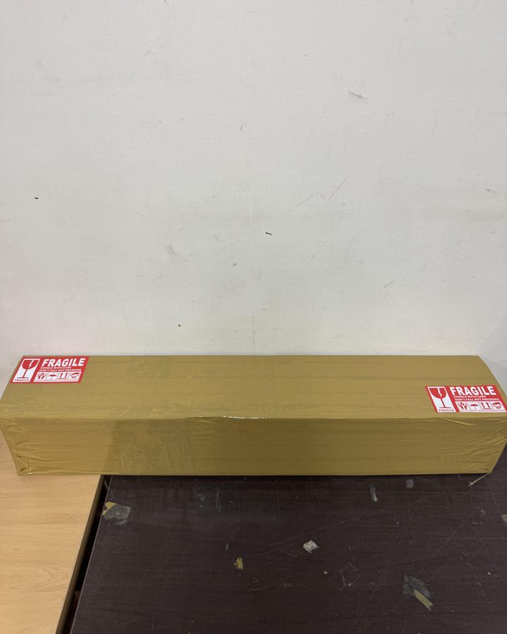 A long box sized to the putter, with FRAGILE labels on both ends